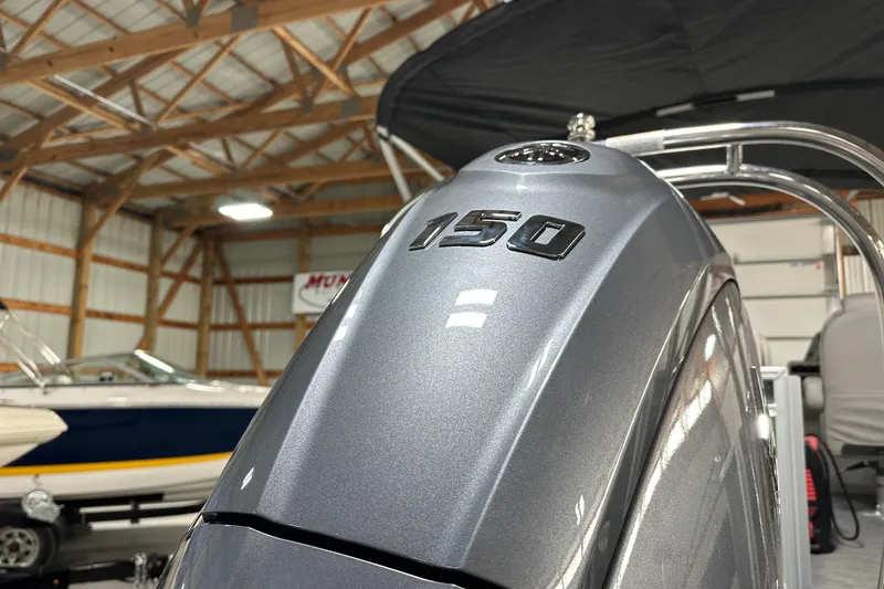 Slide: The Image of Close-up of a 2026 Godfrey Sweetwater 2286 C boat engine with "150" marking. - 5