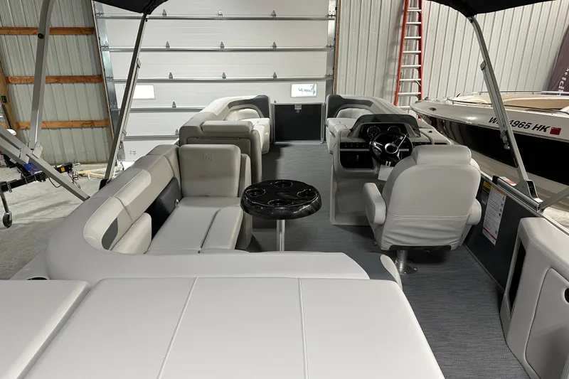 Slide: The Image of 2026 Godfrey Sweetwater 2286 C pontoon boat interior with plush seating and modern helm. - 6