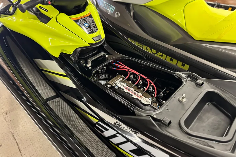 Slide: The Image of 2021 Kawasaki Jetski Ultra 310X engine compartment, vibrant yellow and black design. - 12