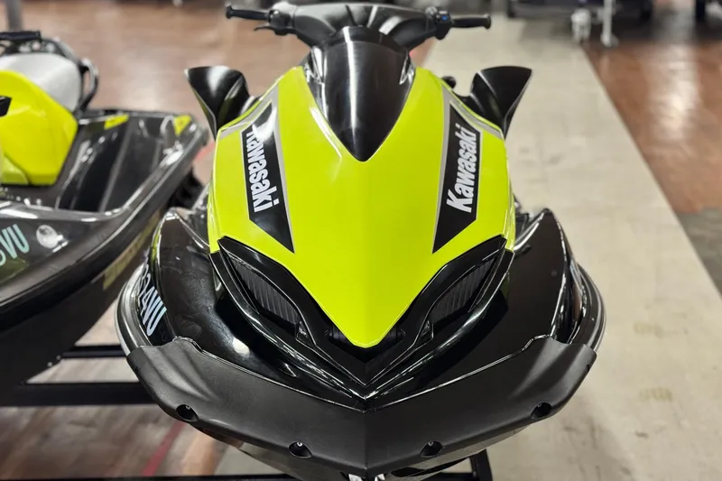 Slide: The Image of 2021 Kawasaki Jetski Ultra 310X in vibrant green and black, front view. - 2