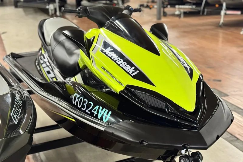 Slide: The Image of 2021 Kawasaki Jetski Ultra 310X in vibrant green and black, displayed indoors. - 3