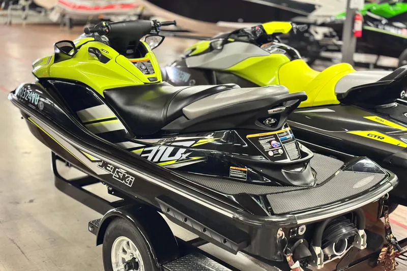 Slide: The Image of 2021 Kawasaki Jetski Ultra 310X in showroom, vibrant yellow and black design. - 4