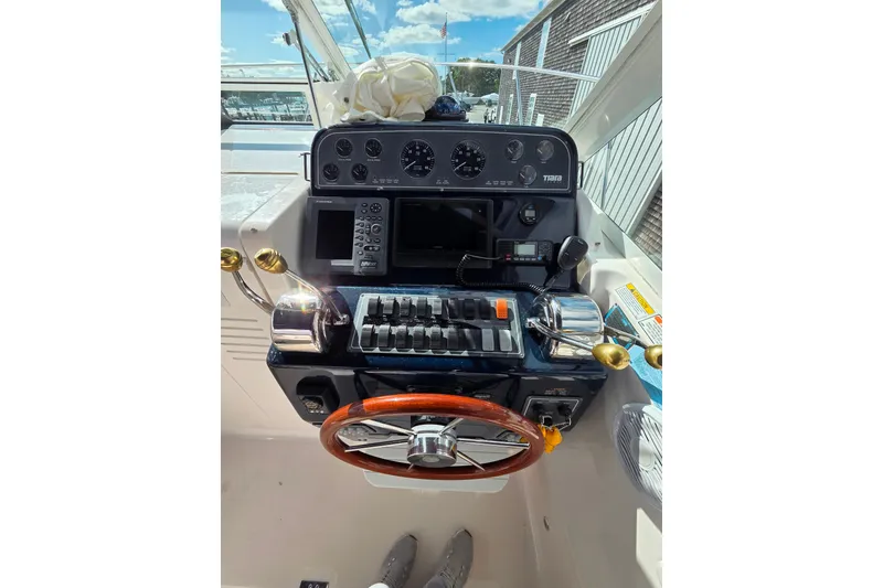 Slide: The Image of 2004 Tiara 29 Coronet Harbor Edition helm with controls and gauges. - 6