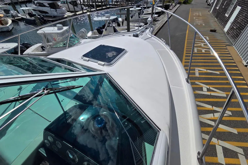 Slide: The Image of 2004 Tiara 29 Coronet Harbor Edition boat docked at marina, showcasing sleek design. - 8