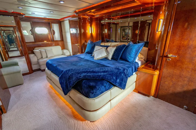 Slide: The Image of Luxurious bedroom interior of 2000 Destiny Flybridge Motor Yacht with elegant blue bedding. - 12