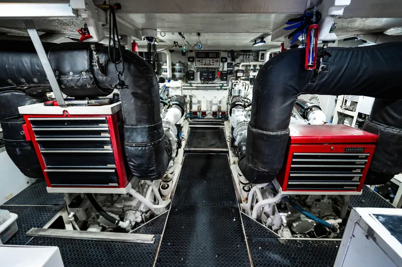 Slide: The Image of Engine room of 2000 Destiny Flybridge Motor Yacht with toolboxes and machinery. - 26