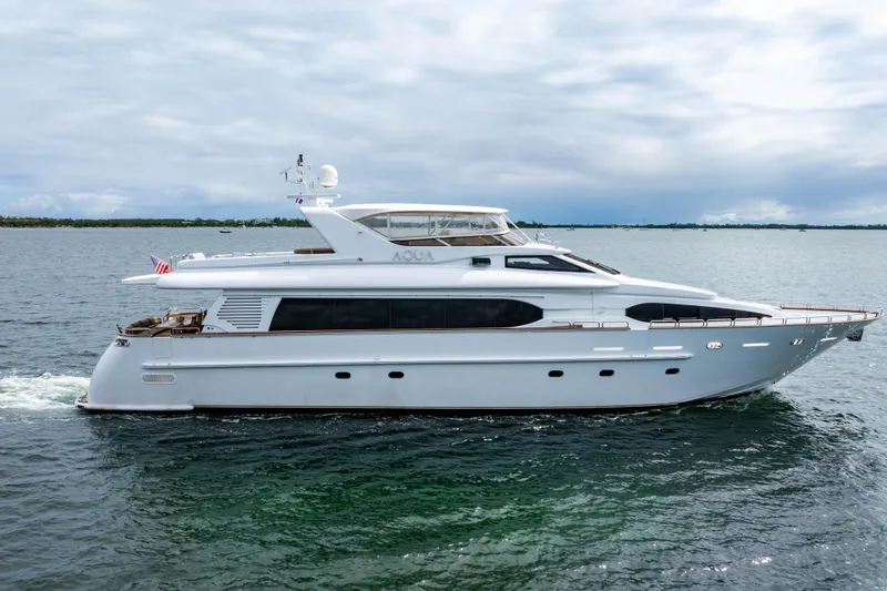 Slide: The Image of 2000 Destiny Flybridge Motor Yacht cruising on open water under cloudy skies. - 28