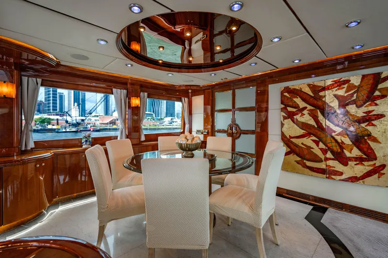 Slide: The Image of Luxurious interior of 2000 Destiny Flybridge Motor Yacht with elegant dining area and city view. - 3