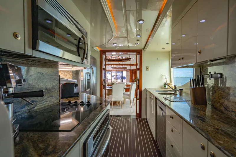 Slide: The Image of Luxurious kitchen interior of 2000 Destiny Flybridge Motor Yacht with modern appliances and elegant design. - 6