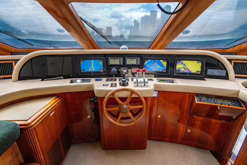 Slide: The Image of Cockpit of 2000 Destiny Flybridge Motor Yacht with navigation screens and wooden steering wheel. - 8