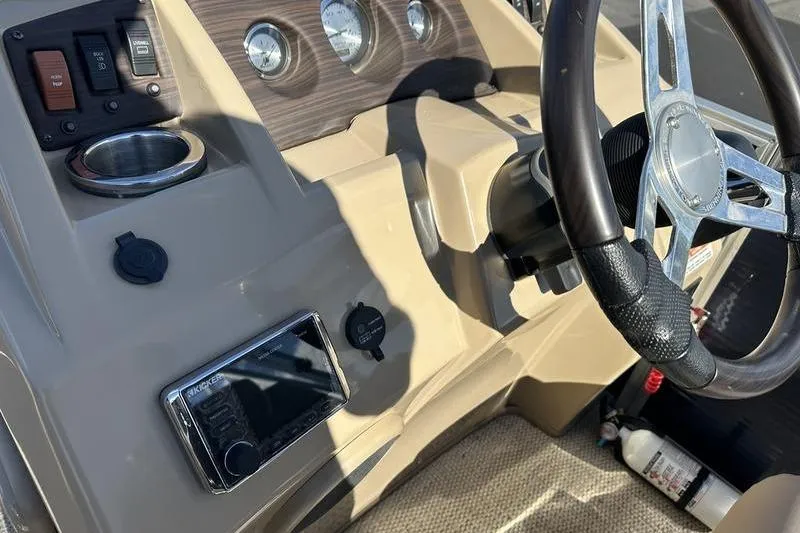 Slide: The Image of Dashboard of a 2018 Bennington 23 SPDX boat with steering wheel and controls. - 12