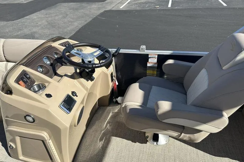 Slide: The Image of 2018 Bennington 23 SPDX boat helm with steering wheel and captain's chair. - 14