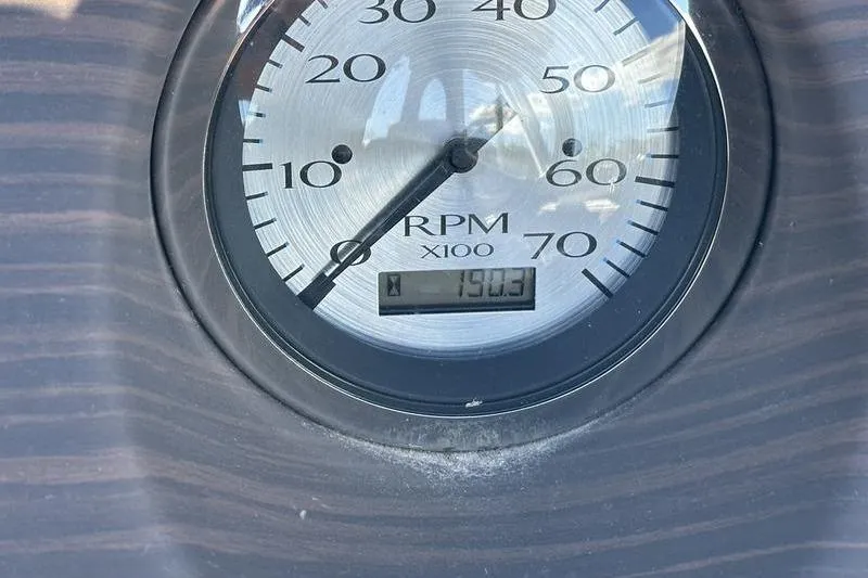Slide: The Image of Close-up of a 2018 Bennington 23 SPDX RPM gauge displaying 1903 hours. - 16