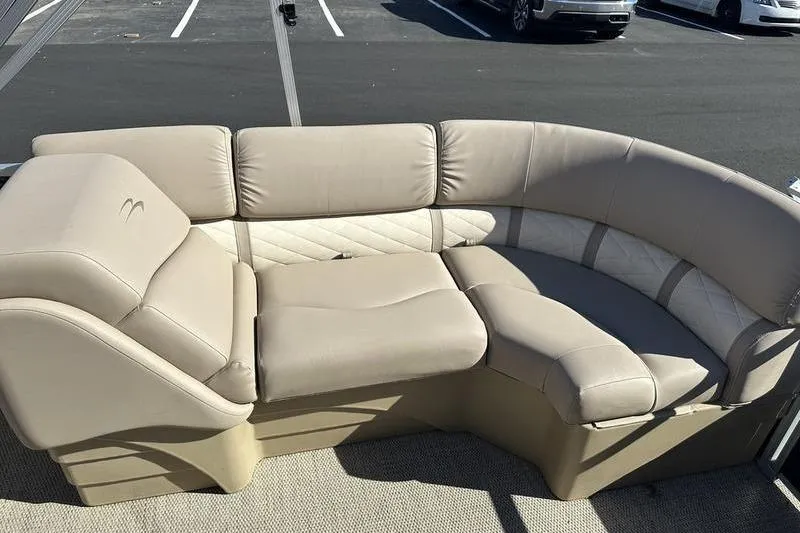 Slide: The Image of 2018 Bennington 23 SPDX boat seating with beige upholstery in a parking lot. - 19