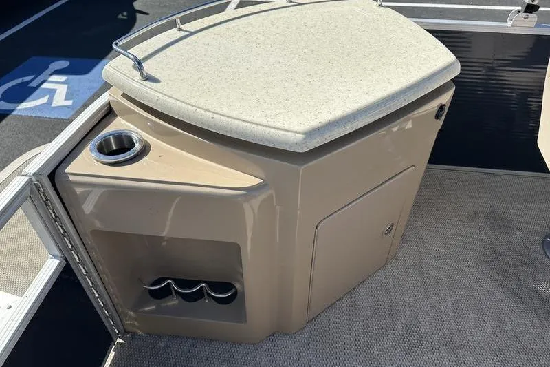 Slide: The Image of 2018 Bennington 23 SPDX boat interior with storage compartment and cup holder. - 22