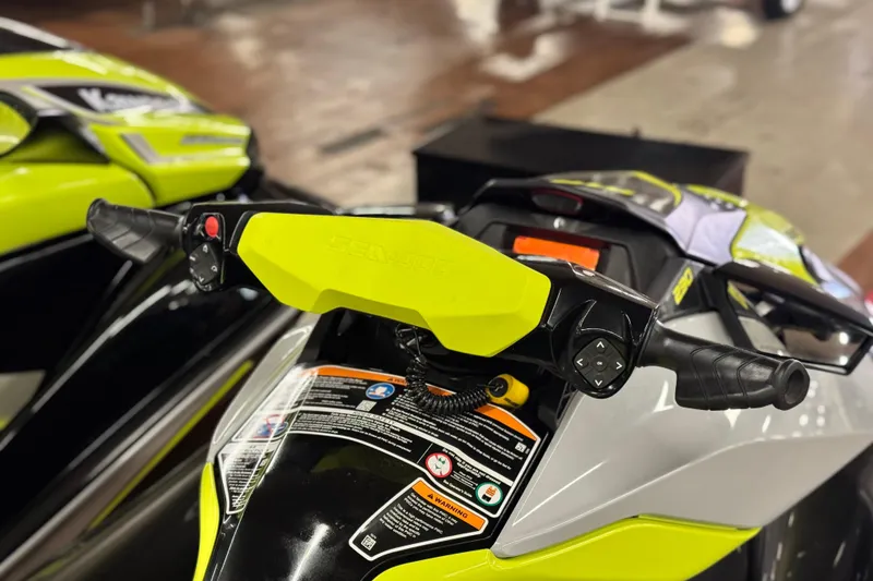 Slide: The Image of 2021 Sea-Doo GTR 230 handlebars and controls, featuring vibrant yellow accents. - 7