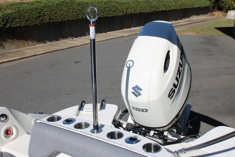 Slide: The Image of 2020 Stingray 192SC boat with Suzuki 150 outboard motor, docked on pavement. - 11
