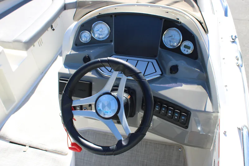 Slide: The Image of 2020 Stingray 192SC boat dashboard with steering wheel and control panel. - 15