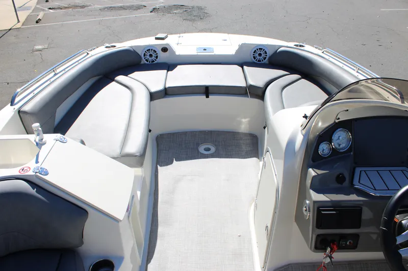 Slide: The Image of 2020 Stingray 192SC boat interior with gray seating and dashboard controls. - 16