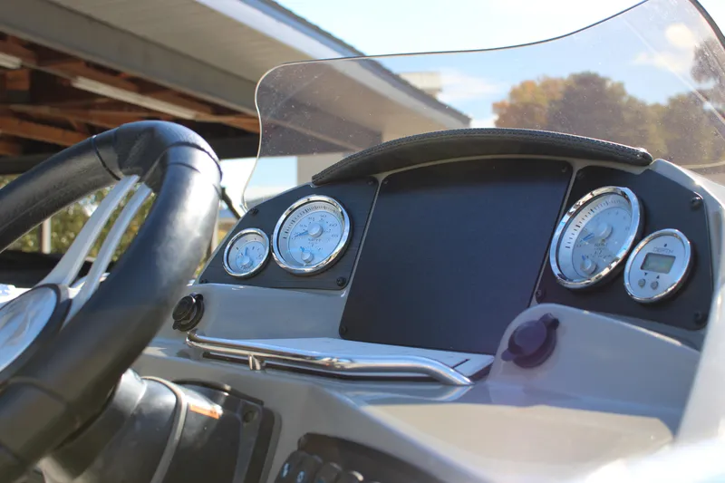 Slide: The Image of 2020 Stingray 192SC boat dashboard with steering wheel and gauges. - 23