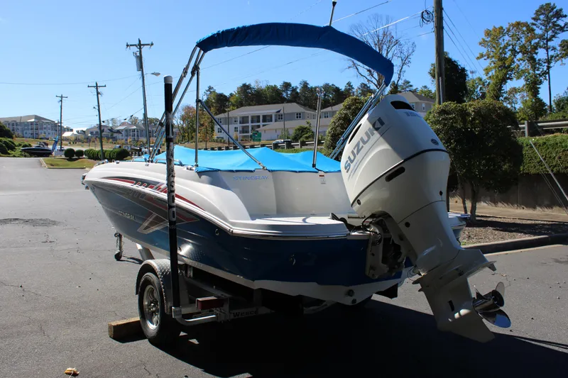 Slide: The Image of 2020 Stingray 192SC boat with Suzuki outboard motor on a trailer. - 27