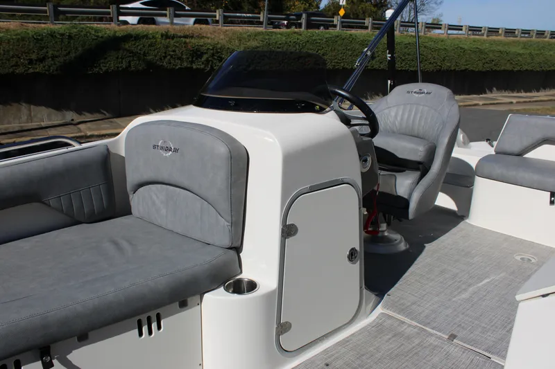 Slide: The Image of 2020 Stingray 192SC boat interior with gray seating and steering console. - 5