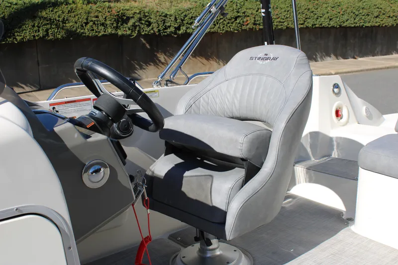 Slide: The Image of 2020 Stingray 192SC boat interior with gray captain's chair and steering wheel. - 7