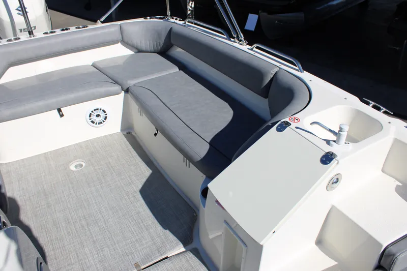 Slide: The Image of 2020 Stingray 192SC boat interior with gray seating and deck, featuring a built-in speaker. - 9