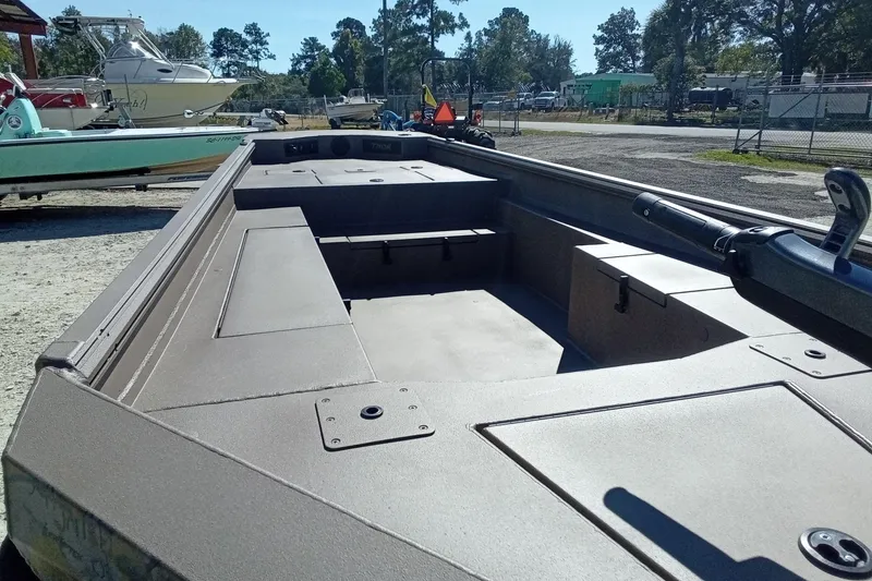 Slide: The Image of 2026 Thor 1754 Fish Hammer boat, spacious interior, docked outdoors. - 16