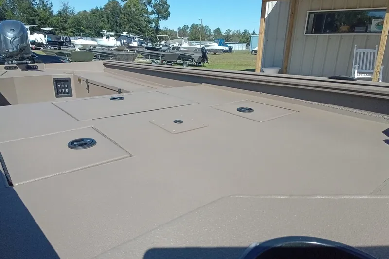 Slide: The Image of 2026 Thor 1754 Fish Hammer boat deck, featuring storage compartments and control panel. - 6