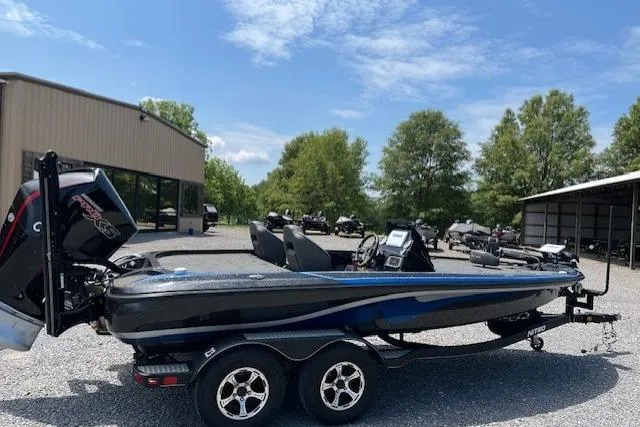 Slide: The Image of 2021 Nitro Z19 boat on trailer, parked outdoors under clear sky. - 4