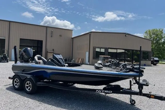 Slide: The Image of 2021 Nitro Z19 boat on trailer in front of industrial buildings under blue sky. - 5