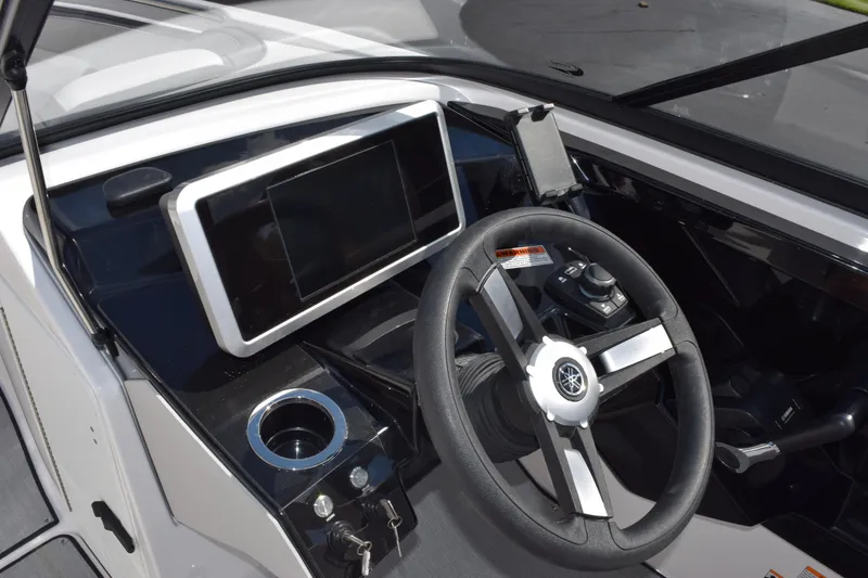 Slide: The Image of 2026 Yamaha AR250 boat dashboard with steering wheel and touchscreen display. - 14