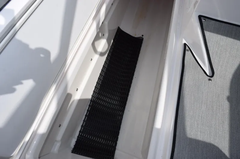 Slide: The Image of 2026 Yamaha Boats AR250 interior with black mat and gray carpet. - 19