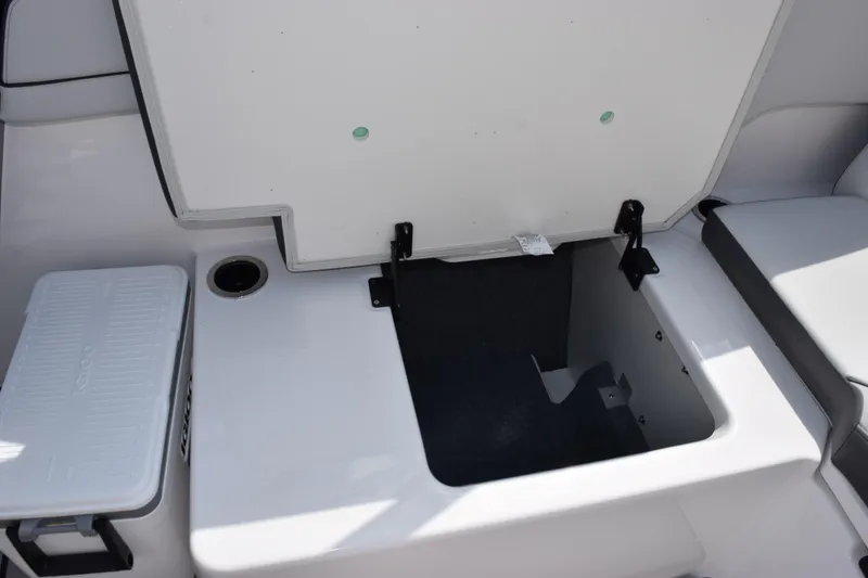 Slide: The Image of 2026 Yamaha AR250 boat storage compartment with open hatch and cooler. - 20