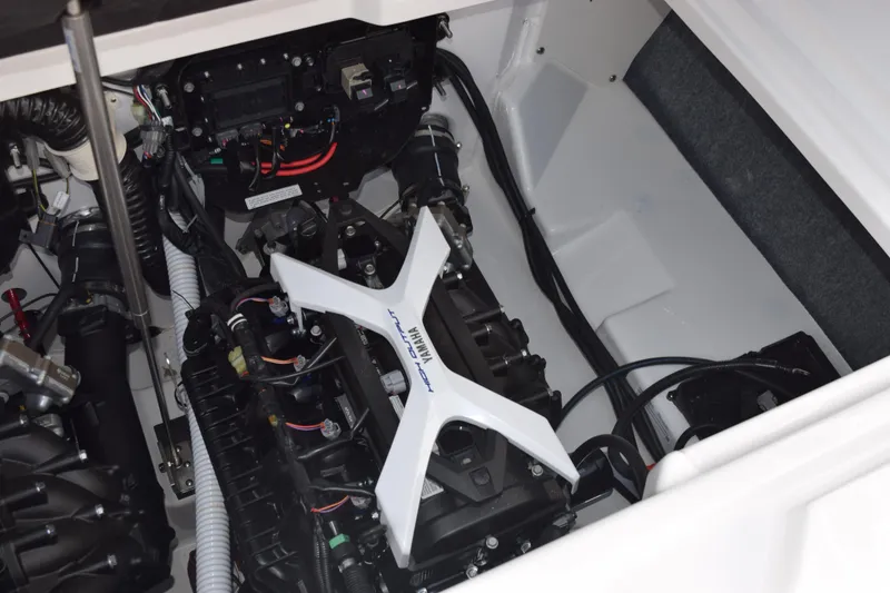 Slide: The Image of Engine compartment of 2026 Yamaha Boats AR250, showcasing advanced mechanical components and wiring. - 23