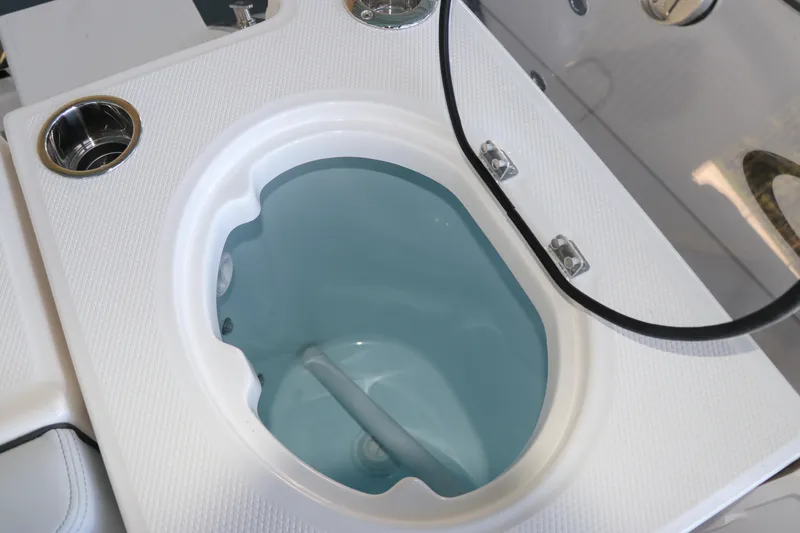 Slide: The Image of 2026 Robalo R250 Center Console livewell with rod holders and clean design. - 15