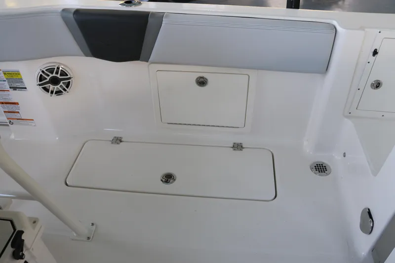 Slide: The Image of 2026 Robalo R250 Center Console boat interior with storage compartments and speaker. - 19