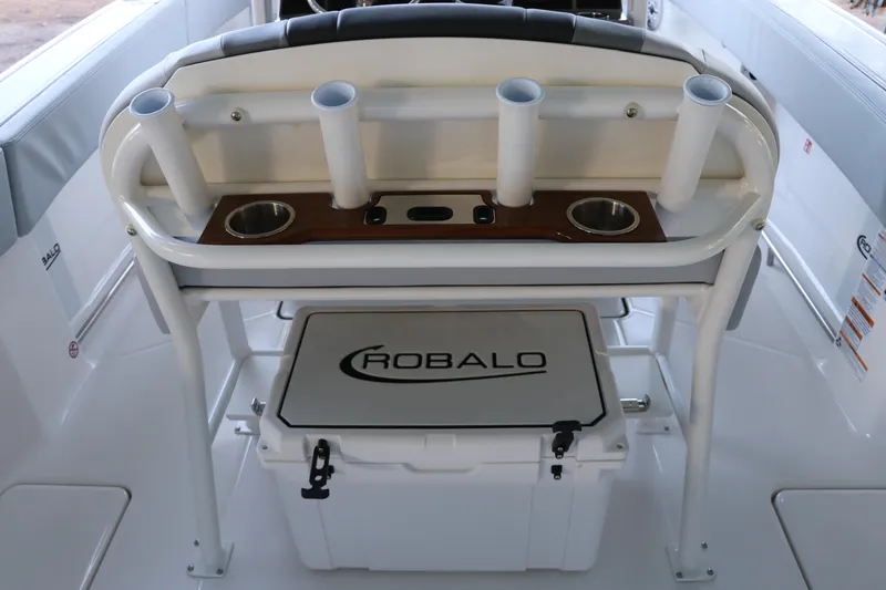 Slide: The Image of 2026 Robalo R250 Center Console boat interior with rod holders and cooler. - 23