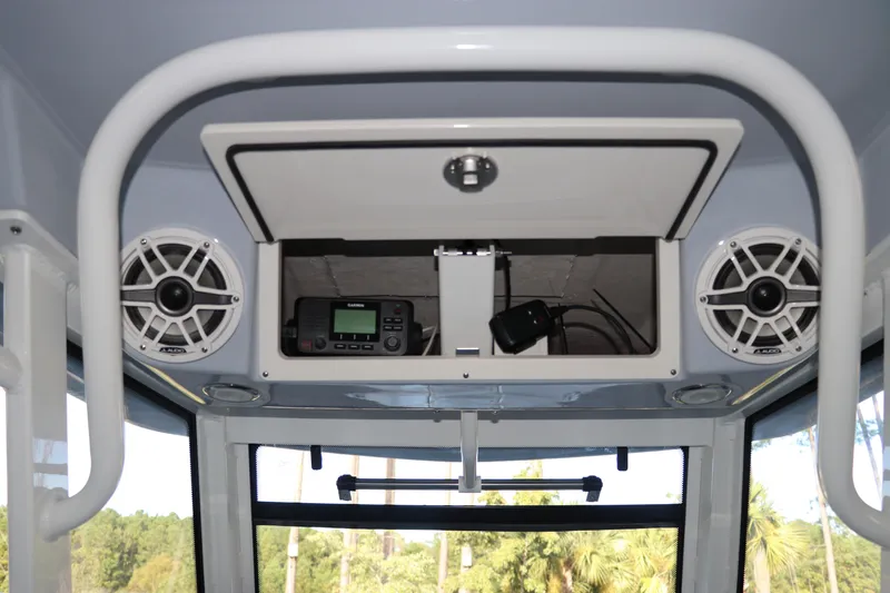 Slide: The Image of 2026 Robalo R250 Center Console boat interior with speakers and electronic equipment. - 26