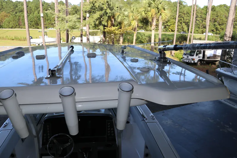 Slide: The Image of 2026 Robalo R250 Center Console boat with rod holders and sleek design in a scenic setting. - 27