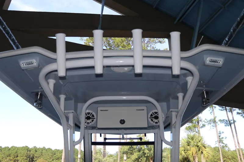 Slide: The Image of 2026 Robalo R250 Center Console boat with rod holders and speakers under a canopy. - 30