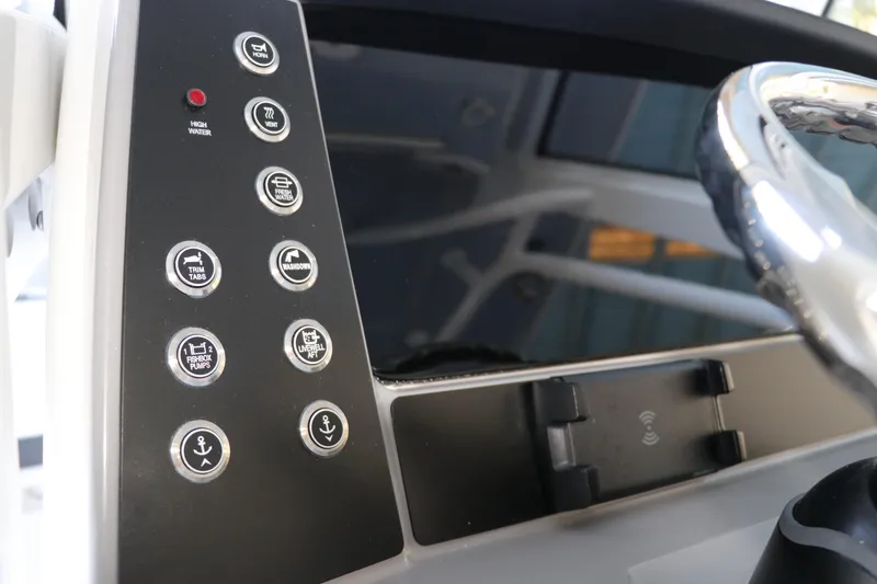 Slide: The Image of 2026 Robalo R250 Center Console dashboard with control buttons and steering wheel. - 32