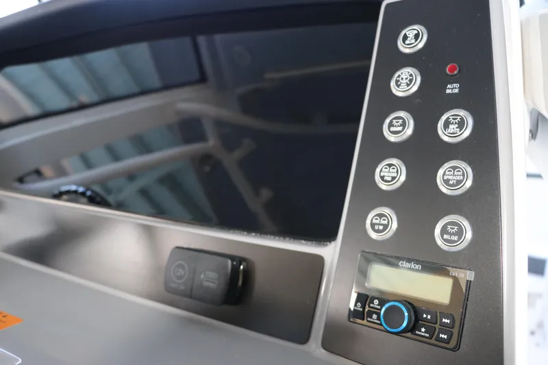 Slide: The Image of Control panel of 2026 Robalo R250 Center Console boat with various buttons and display. - 36