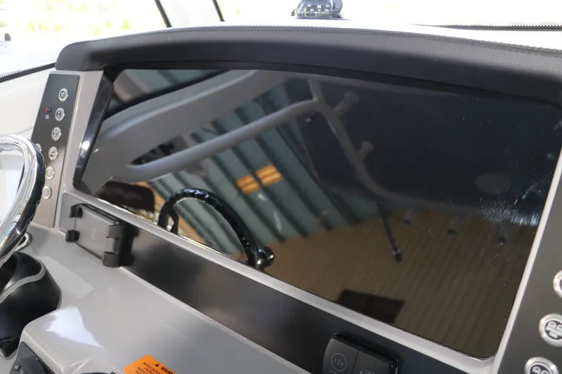Slide: The Image of 2026 Robalo R250 Center Console dashboard with steering wheel and control panel. - 37