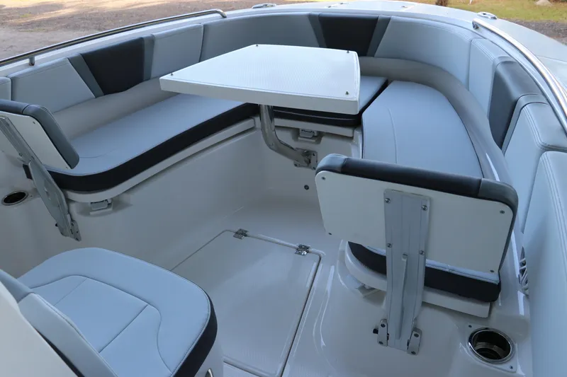 Slide: The Image of 2026 Robalo R250 Center Console boat interior with seating and table setup. - 49