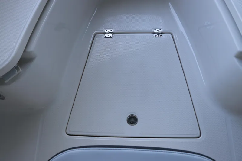 Slide: The Image of 2026 Robalo R250 Center Console boat storage compartment with secure latch. - 57