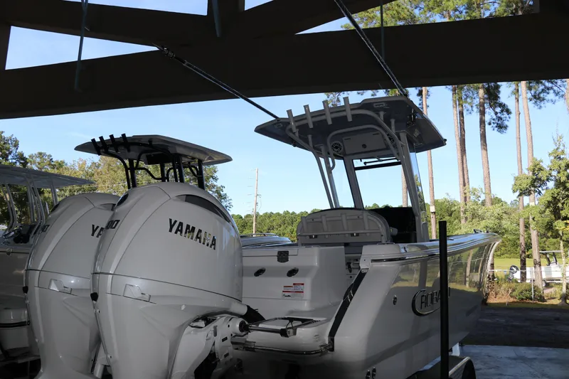 Slide: The Image of 2026 Robalo R250 Center Console boat with Yamaha engines, parked outdoors. - 7