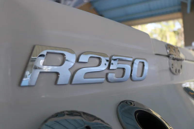 Slide: The Image of 2026 Robalo R250 Center Console boat emblem in close-up view. - 9