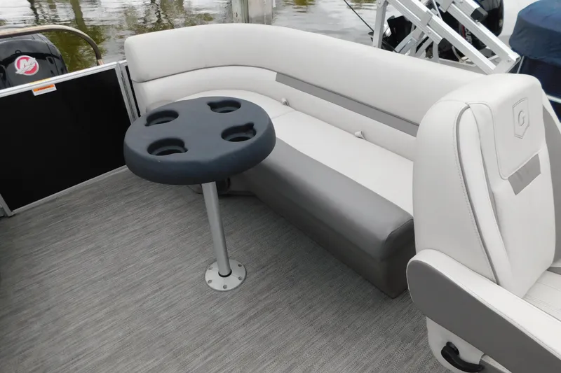 Slide: The Image of 2021 Godfrey Sweetwater 2286 SBX pontoon boat interior with seating and cupholder table. - 21
